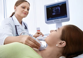 Doctor performing ultrasound on patient